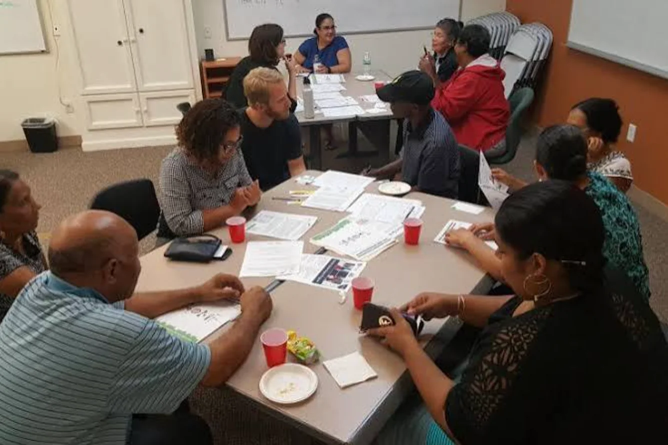 Community members collaborating around a table